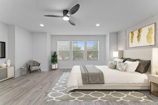 a bedroom with a large bed couch and a window