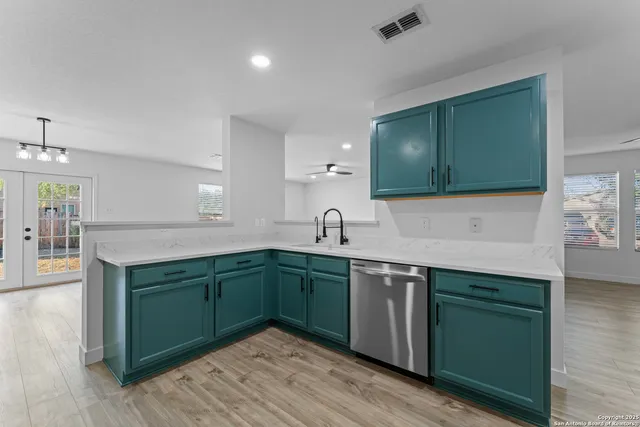 a kitchen with sink and cabinets