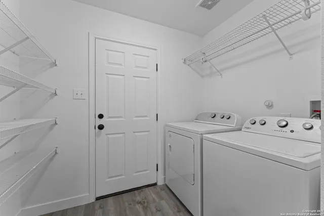 a view of storage and utility room with washer and dryer