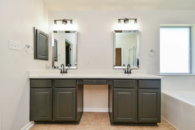 a bathroom with a double vanity sink and mirror