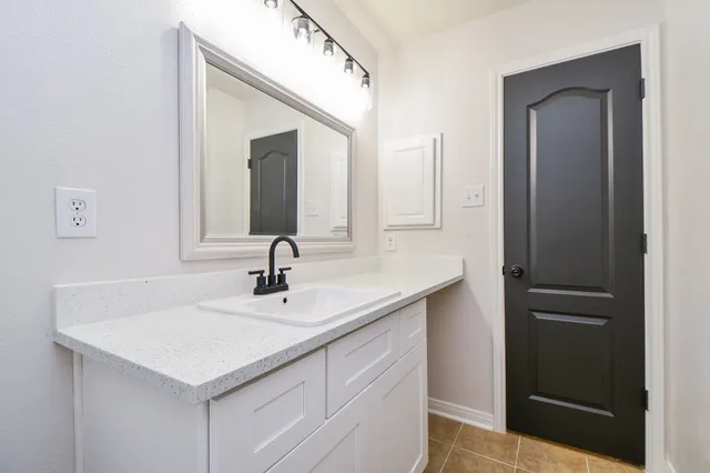 a bathroom with a sink and a mirror
