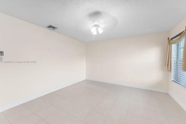 an empty room with a empty space and windows