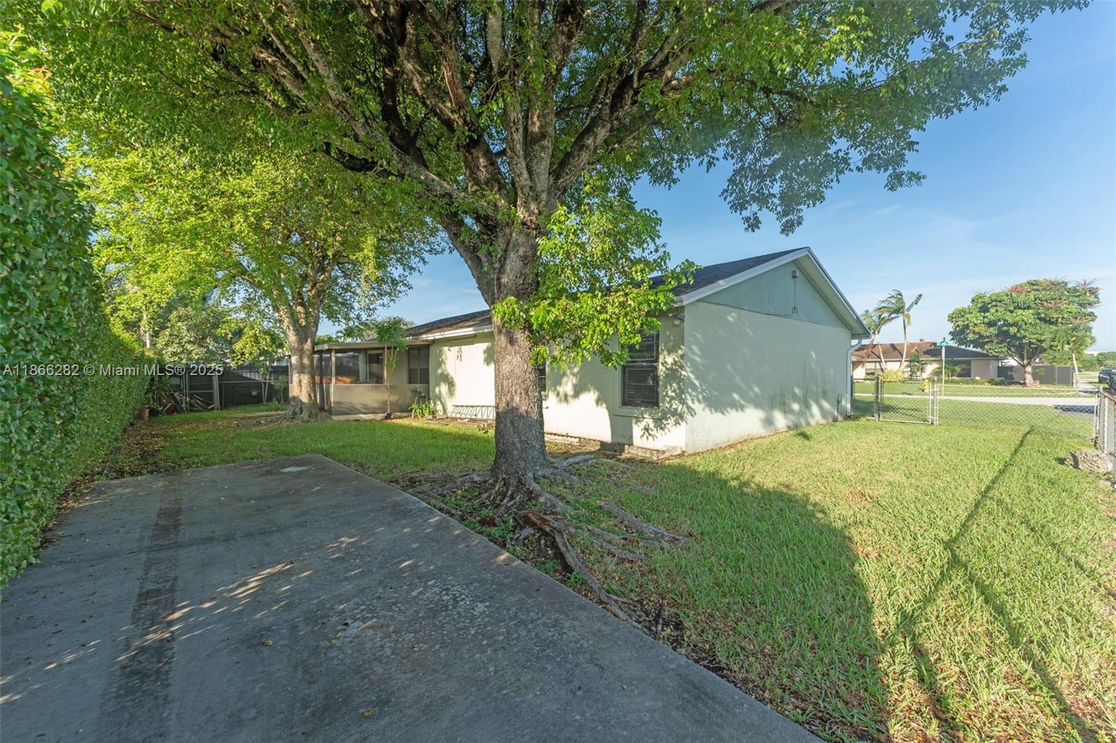13231 Southwest 86th Street Miami, FL 33183 - Photo 21 of 31 a view of a yard with plants and large trees