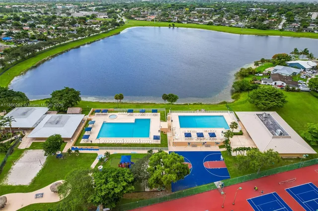 an aerial view of a pool patio lake and lake view