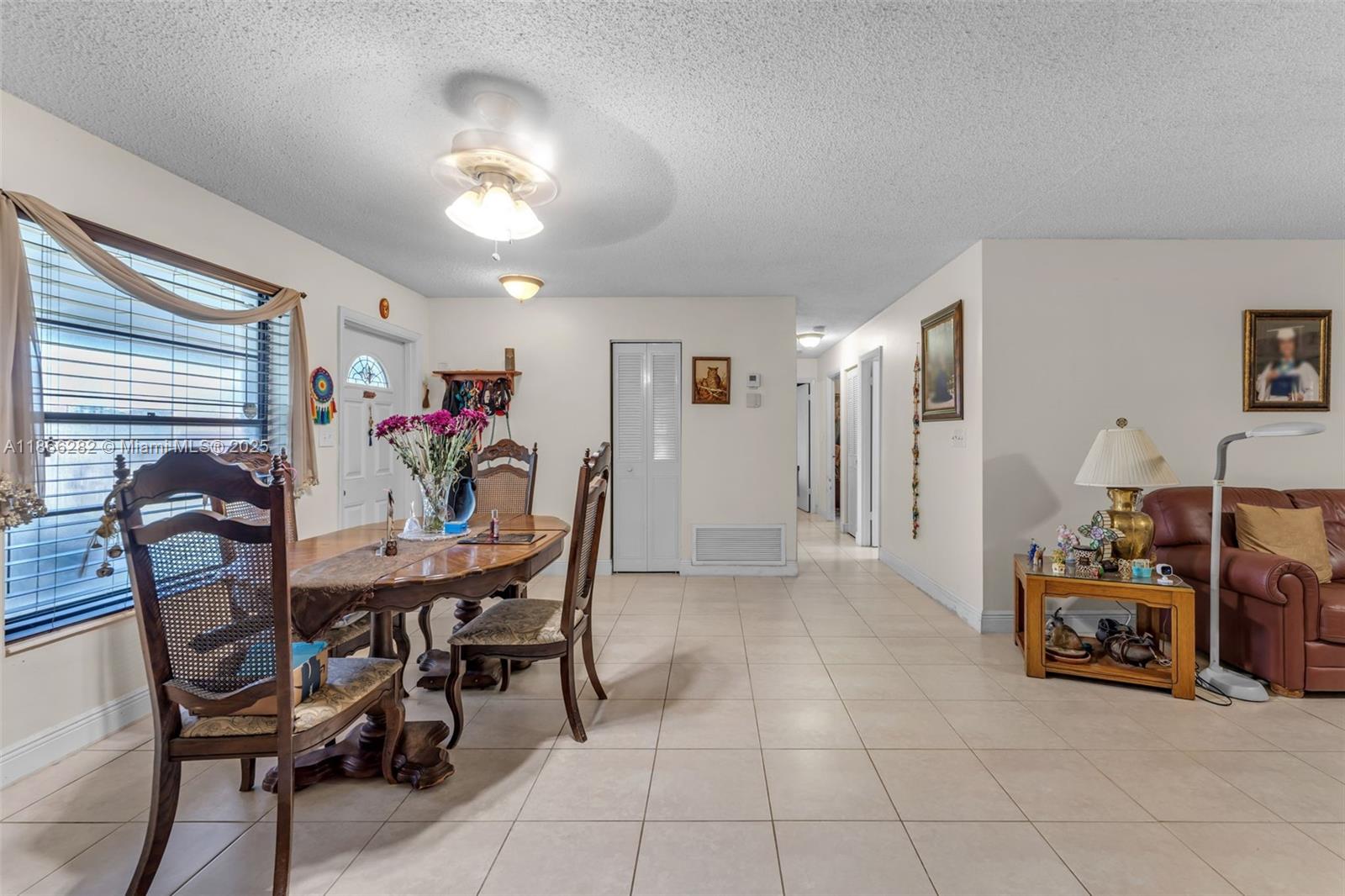 13231 Southwest 86th Street Miami, FL 33183 - Photo 8 of 31 a view of a dining room with furniture and chandelier