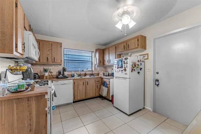 a kitchen with cabinets and steel stainless steel appliances
