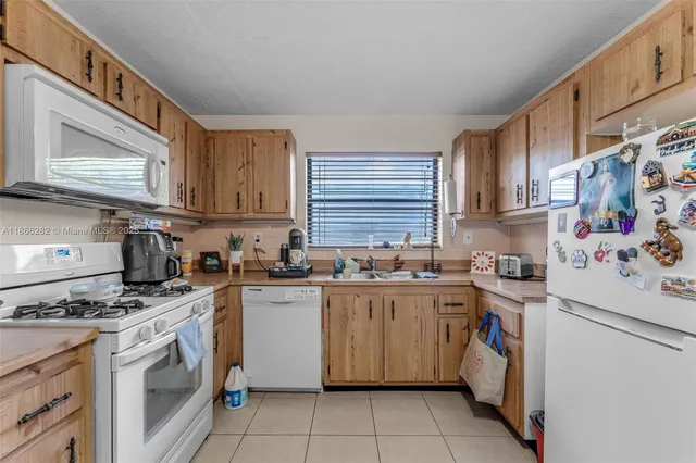 a kitchen with a stove top oven sink and cabinets