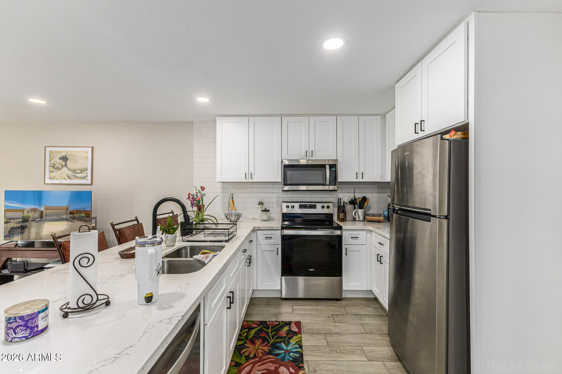 847 West Rice Drive Tempe, AZ 85283 - Photo 11 of 40 a kitchen with stainless steel appliances a refrigerator sink and white cabinets