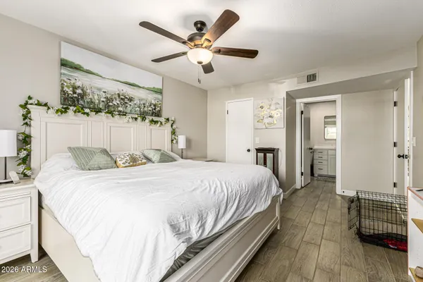 a bedroom with bed and wooden floor
