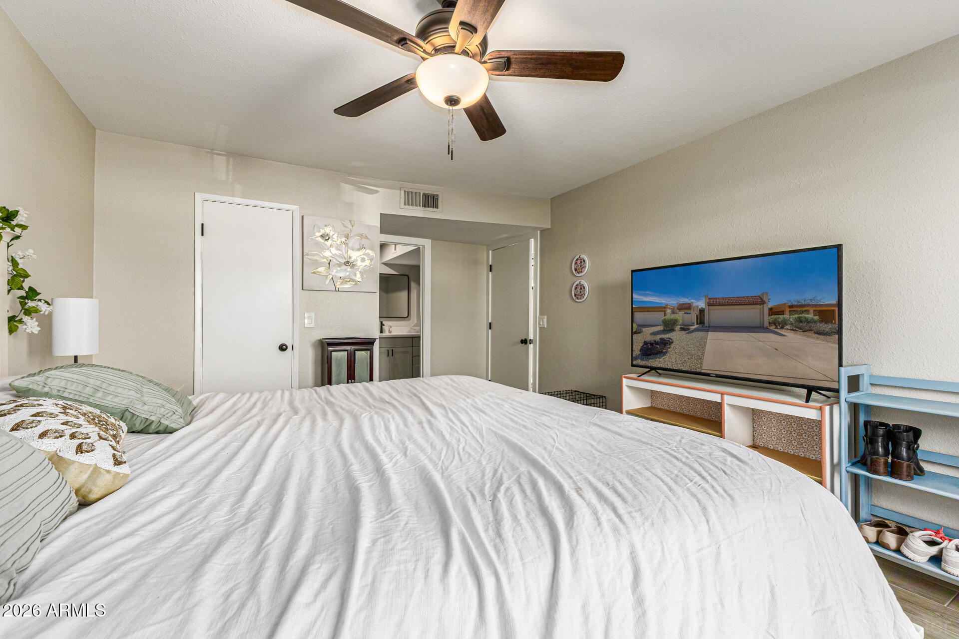 847 West Rice Drive Tempe, AZ 85283 - Photo 17 of 40 a bedroom with a large bed and a chandelier