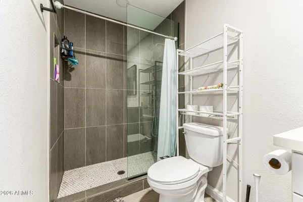 a white toilet sitting next to a bathroom sink