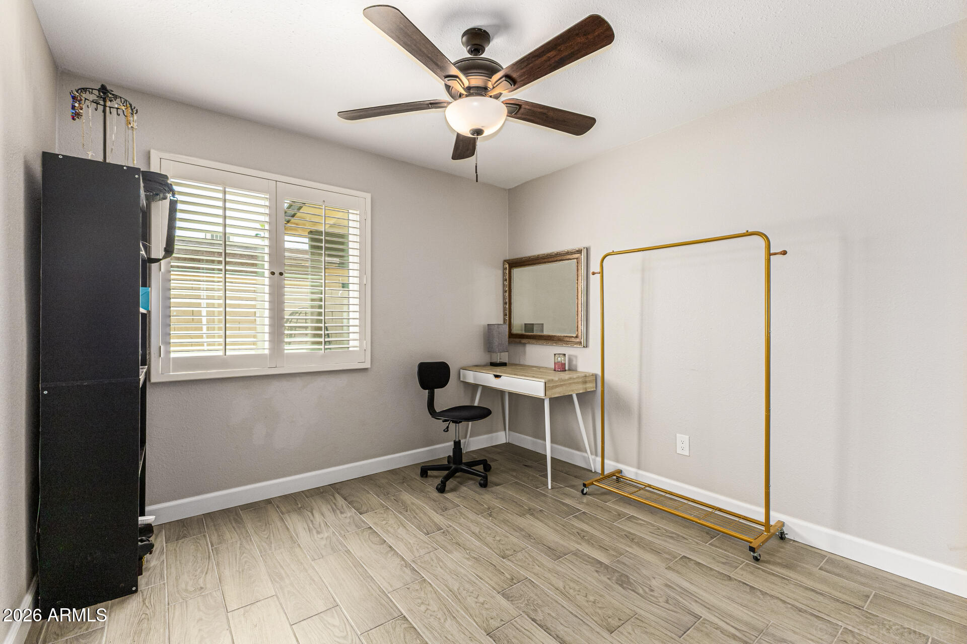 847 West Rice Drive Tempe, AZ 85283 - Photo 20 of 40 a work room with wooden floor and a ceiling fan