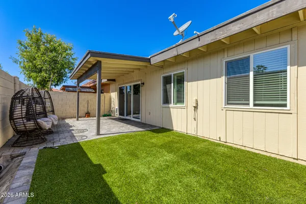 a view of a house with backyard and a tree