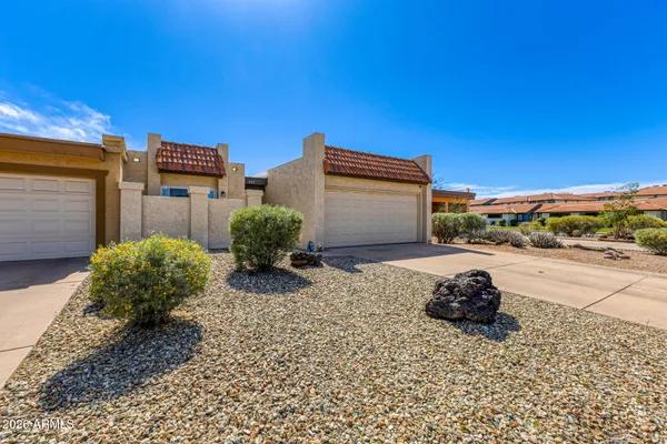 a street view with a building and trees in the background