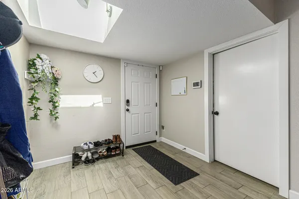 a view of a room with wooden floor and windows