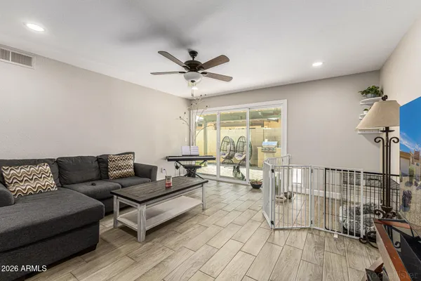 a living room with furniture and a wooden floor