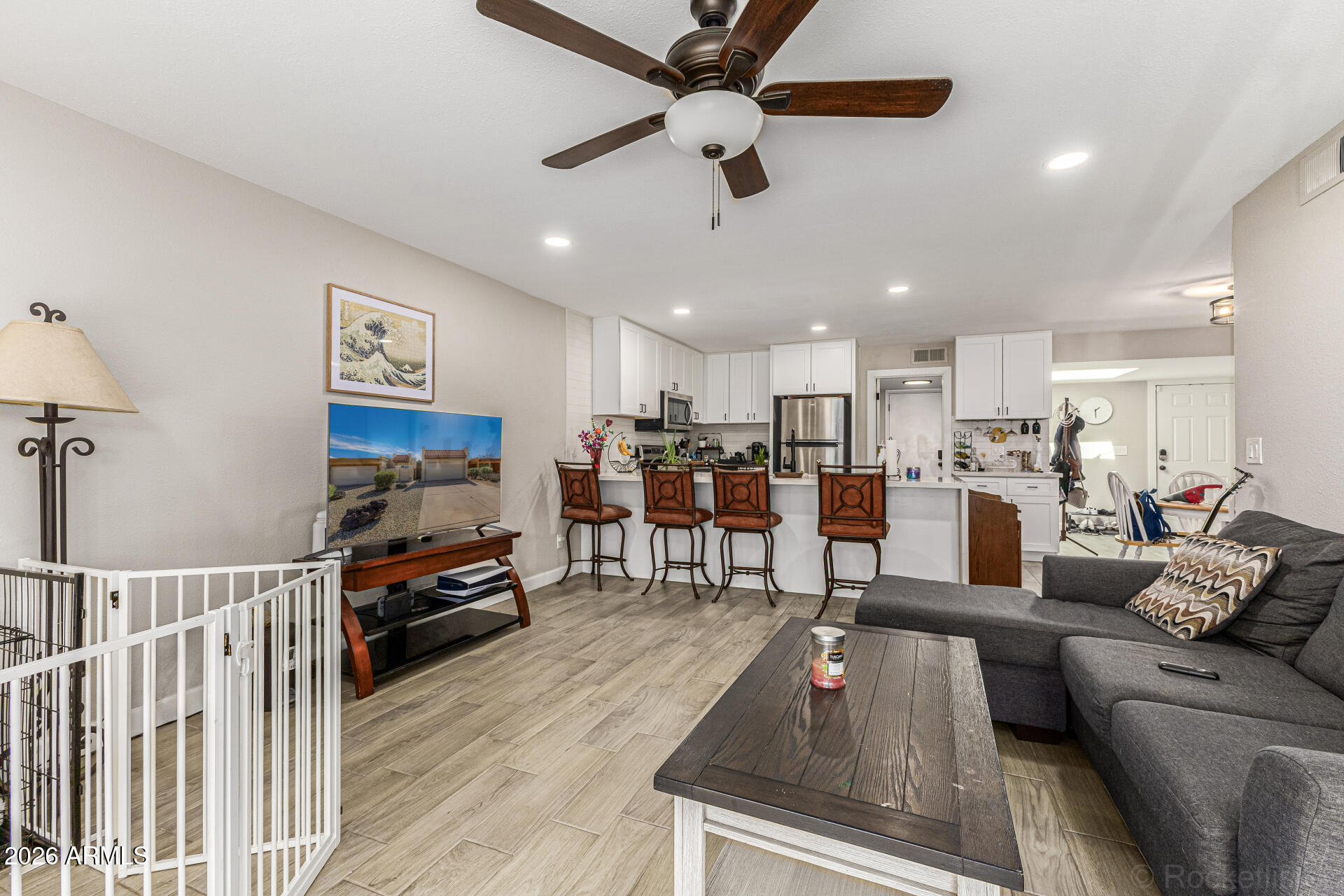 847 West Rice Drive Tempe, AZ 85283 - Photo 8 of 40 a living room with furniture kitchen view and a flat screen tv
