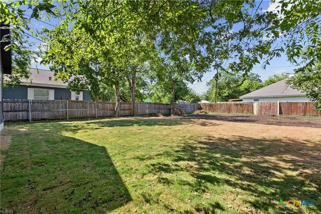 a swimming pool with outdoor seating and yard