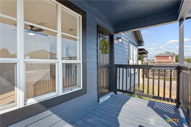 a view of a balcony with wooden floor
