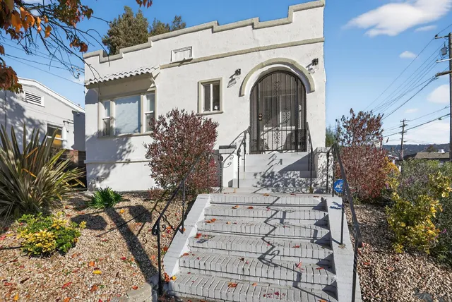 a view of a white house with large windows