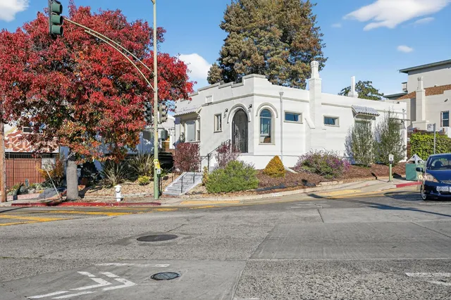 a view of a white apartments with large windows