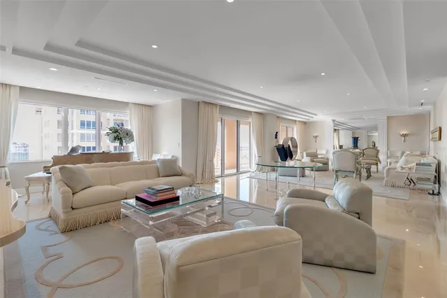 a living room with furniture and view of kitchen