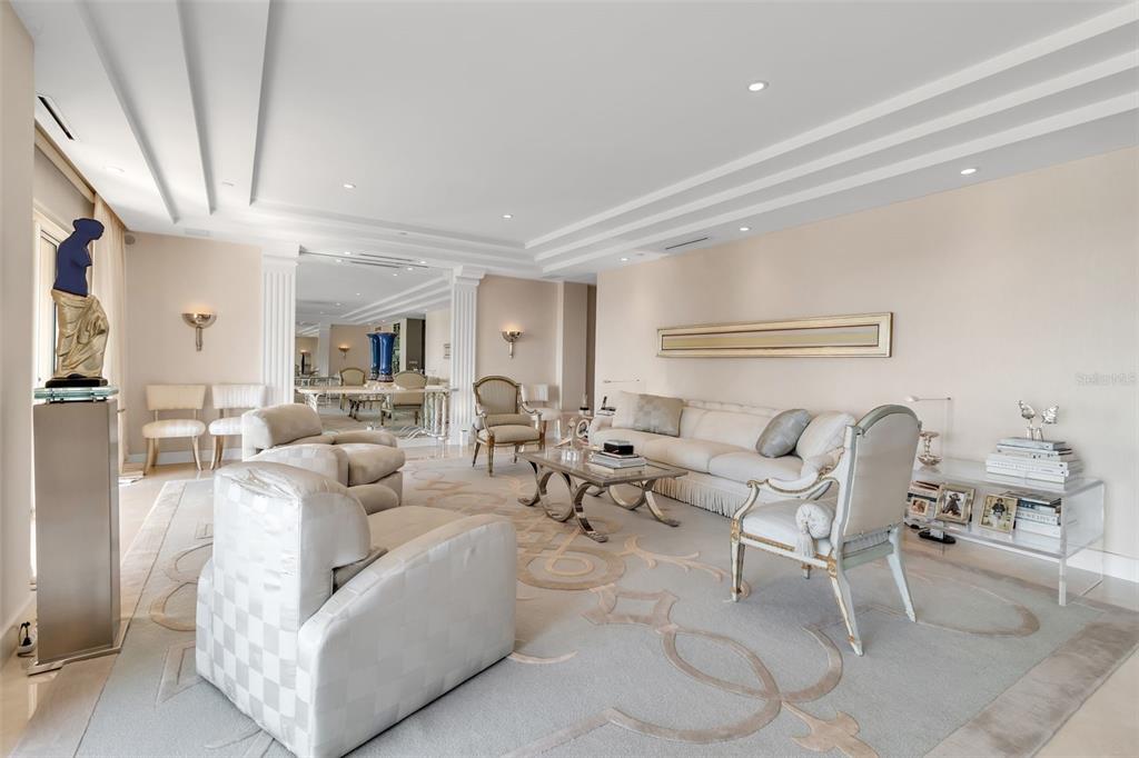 1111 Ritz Carlton Drive, Unit 1202 Sarasota, FL 34236 - Photo 14 of 49 a living room with furniture and a table