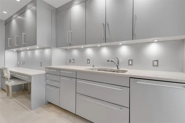a kitchen with sink and cabinets