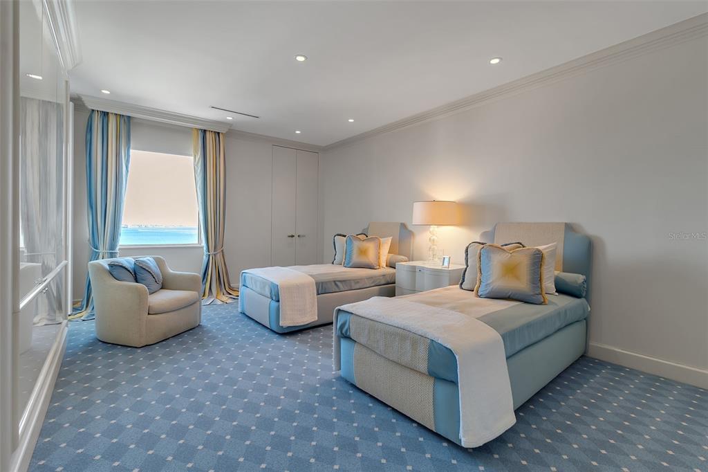 1111 Ritz Carlton Drive, Unit 1202 Sarasota, FL 34236 - Photo 31 of 49 a spacious bedroom with a bed and large windows