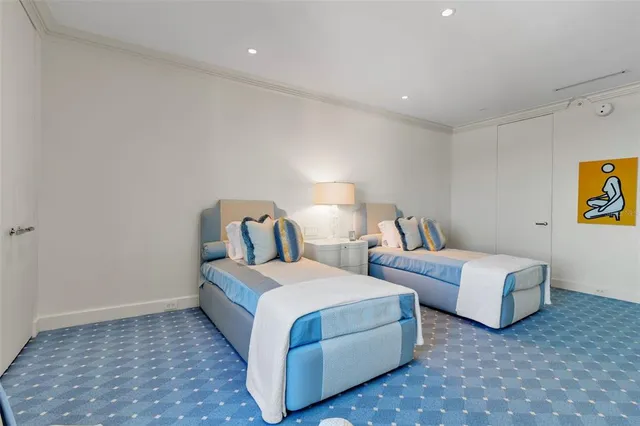 a room with two beds and painting on the wall