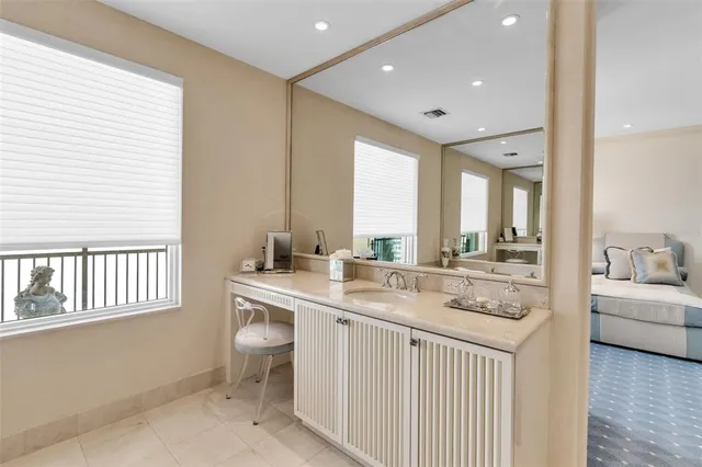 a large white kitchen with a large window