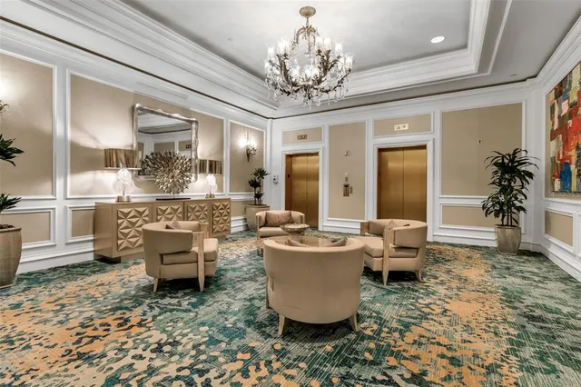 a living room with furniture and a chandelier