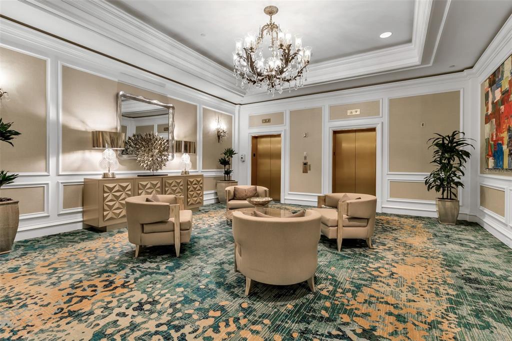 1111 Ritz Carlton Drive, Unit 1202 Sarasota, FL 34236 - Photo 39 of 49 a living room with furniture and a chandelier