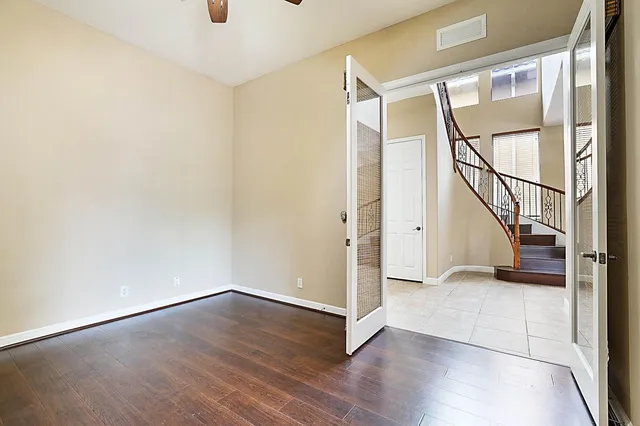 an empty room with windows and entrance