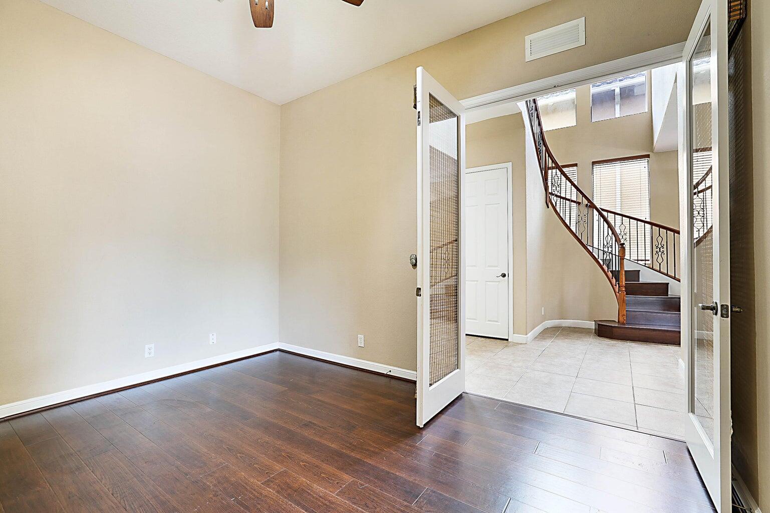 748 Cresta Circle West Palm Beach, FL 33413 - Photo 11 of 62 an empty room with wooden floor and windows