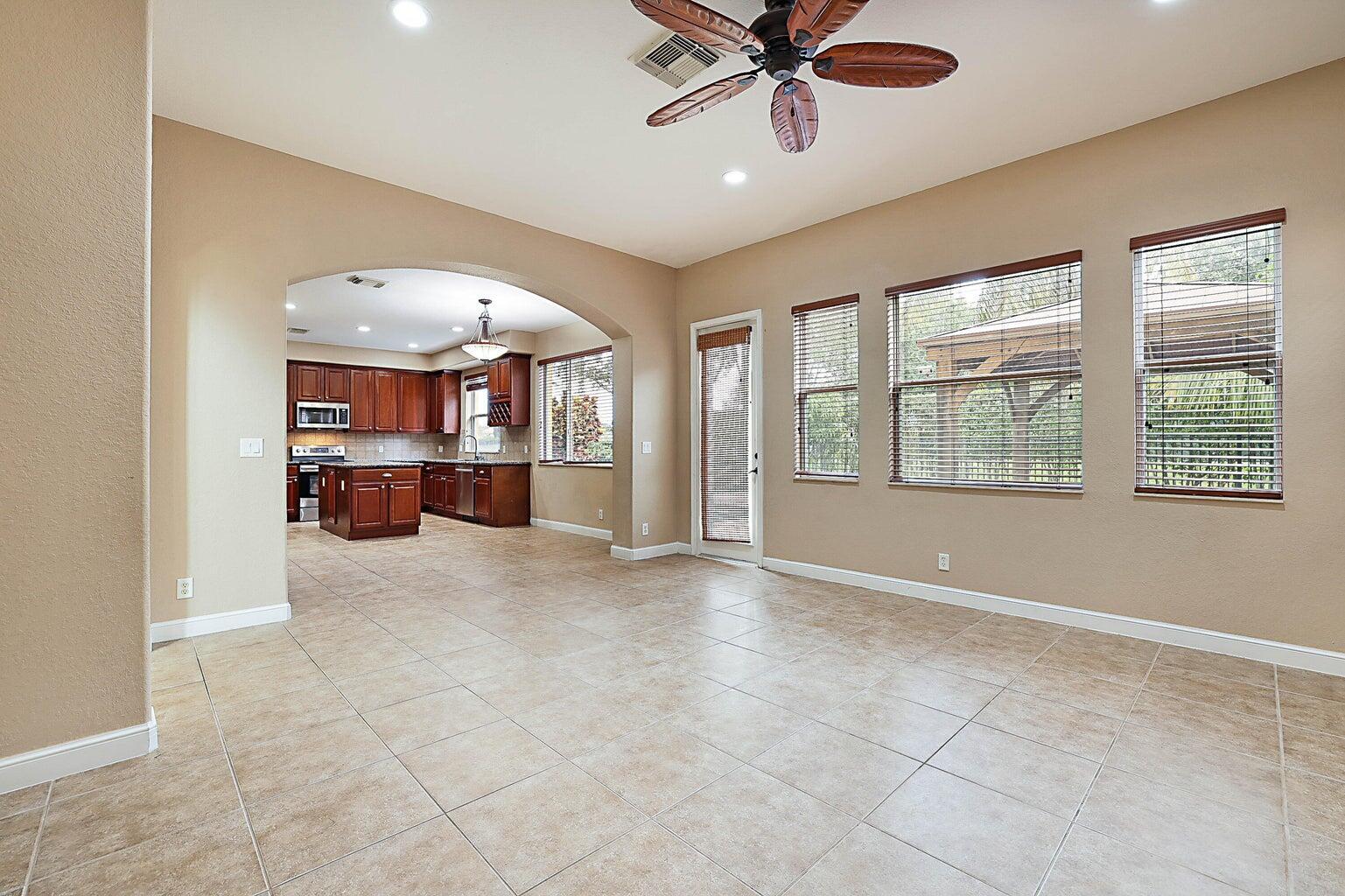 748 Cresta Circle West Palm Beach, FL 33413 - Photo 19 of 62 an empty room with windows and ceiling fan