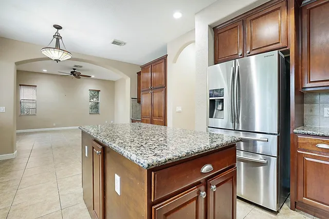 a kitchen with stainless steel appliances granite countertop a refrigerator and a stove