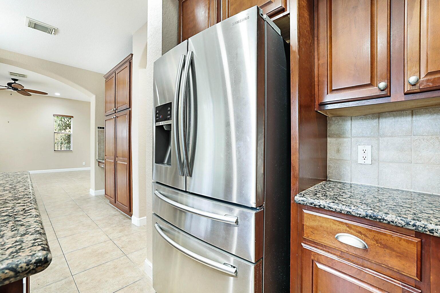 748 Cresta Circle West Palm Beach, FL 33413 - Photo 26 of 62 a kitchen with stainless steel appliances granite countertop a refrigerator and a stove
