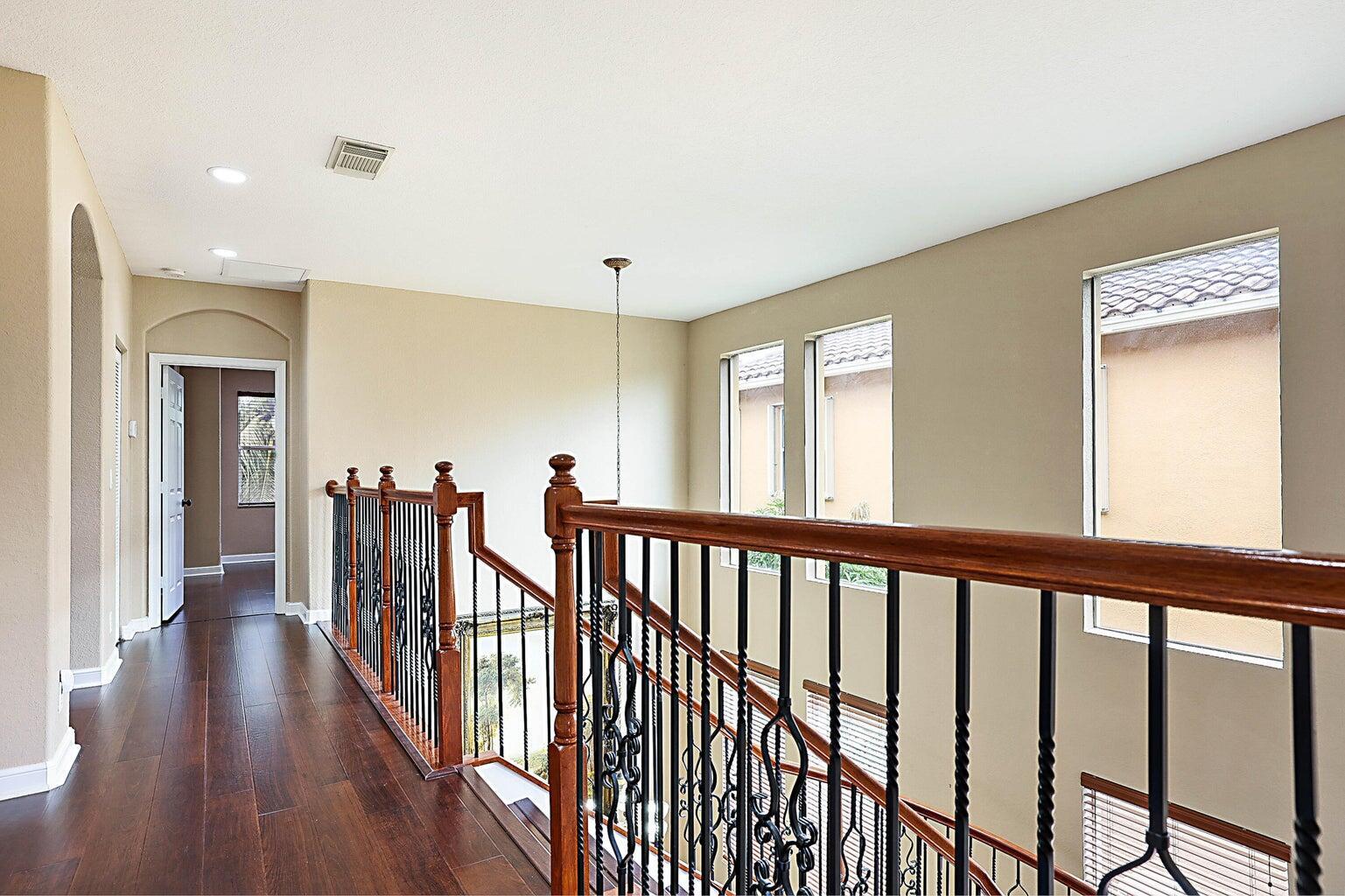 748 Cresta Circle West Palm Beach, FL 33413 - Photo 29 of 62 a view of hallway with wooden floor and stairs