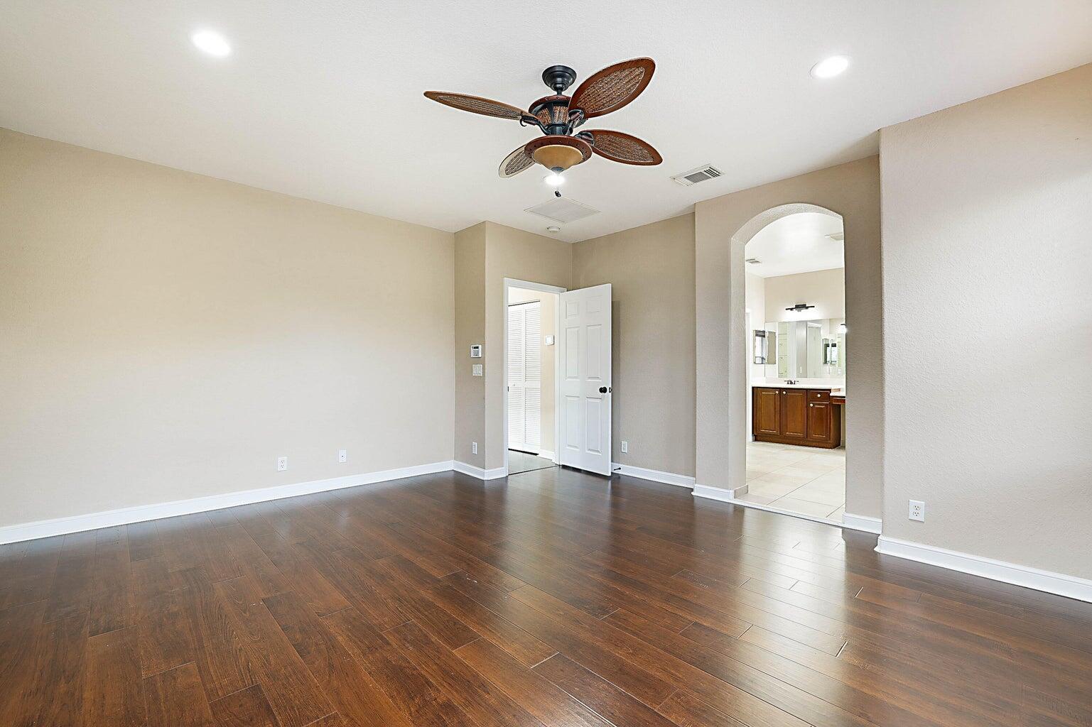 748 Cresta Circle West Palm Beach, FL 33413 - Photo 33 of 62 an empty room with wooden floor and a ceiling fan