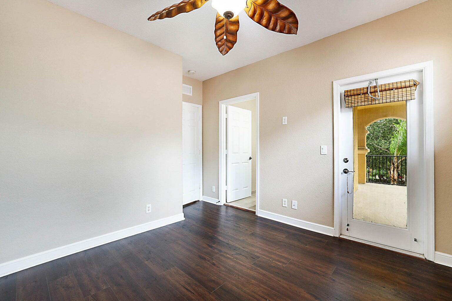 748 Cresta Circle West Palm Beach, FL 33413 - Photo 37 of 62 an empty room with wooden floor and windows