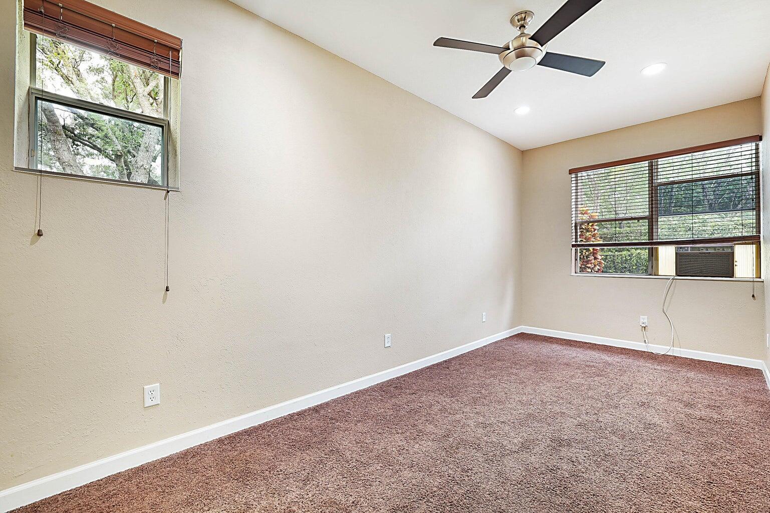 748 Cresta Circle West Palm Beach, FL 33413 - Photo 42 of 62 an empty room with windows and ceiling fan