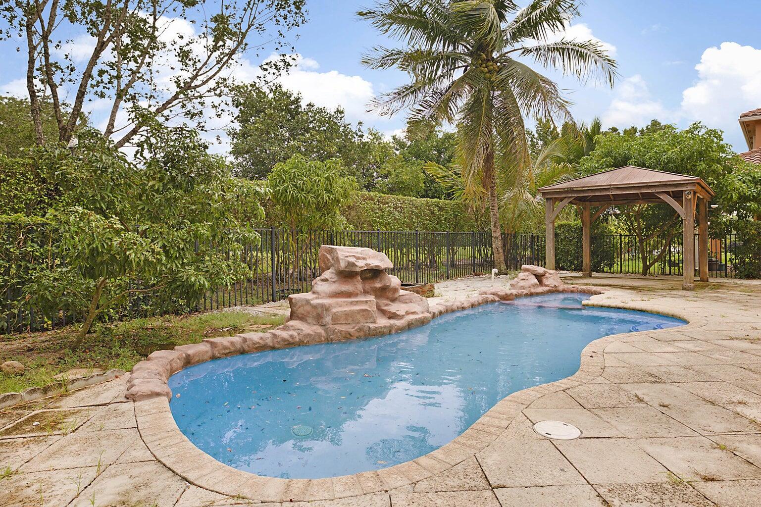 748 Cresta Circle West Palm Beach, FL 33413 - Photo 52 of 62 a view of a swimming pool with a patio