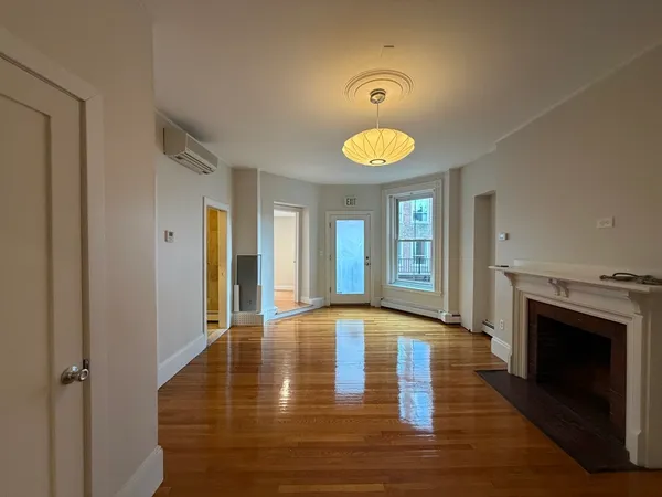 a view of an entryway with wooden floor