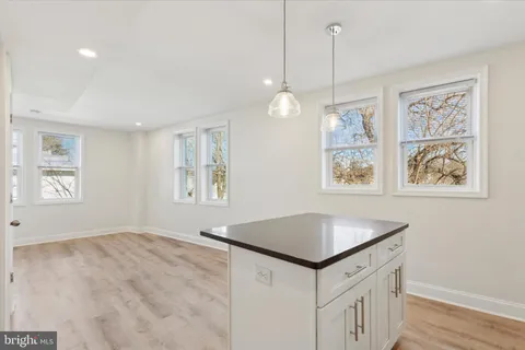 a kitchen that has a lot of windows in it