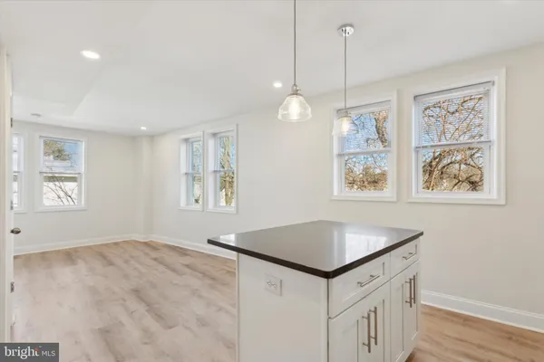 a kitchen that has a lot of windows in it