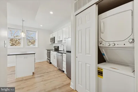 a kitchen with refrigerator and cabinets