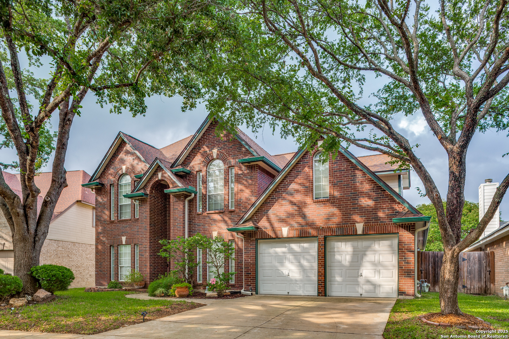 a view of a large trees in front of a house