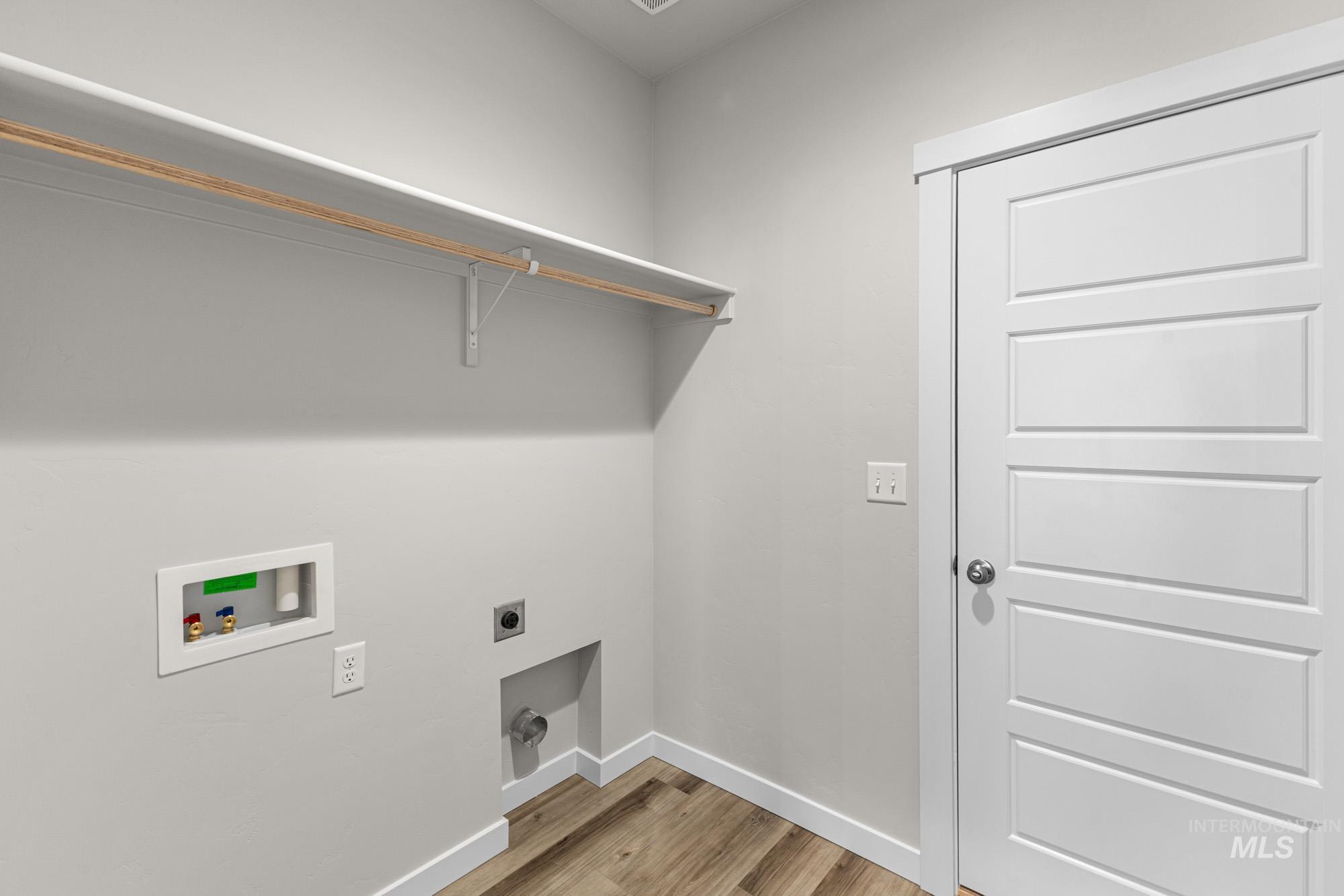 10467 West Tinder Street Star, ID 83669 - Photo 11 of 21 Laundry area featuring hookup for an electric dryer, light wood finished floors, and washer hookup