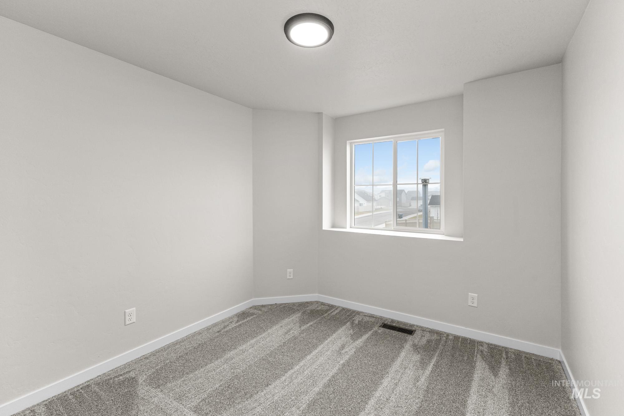 10467 West Tinder Street Star, ID 83669 - Photo 13 of 21 Carpeted spare room featuring baseboards
